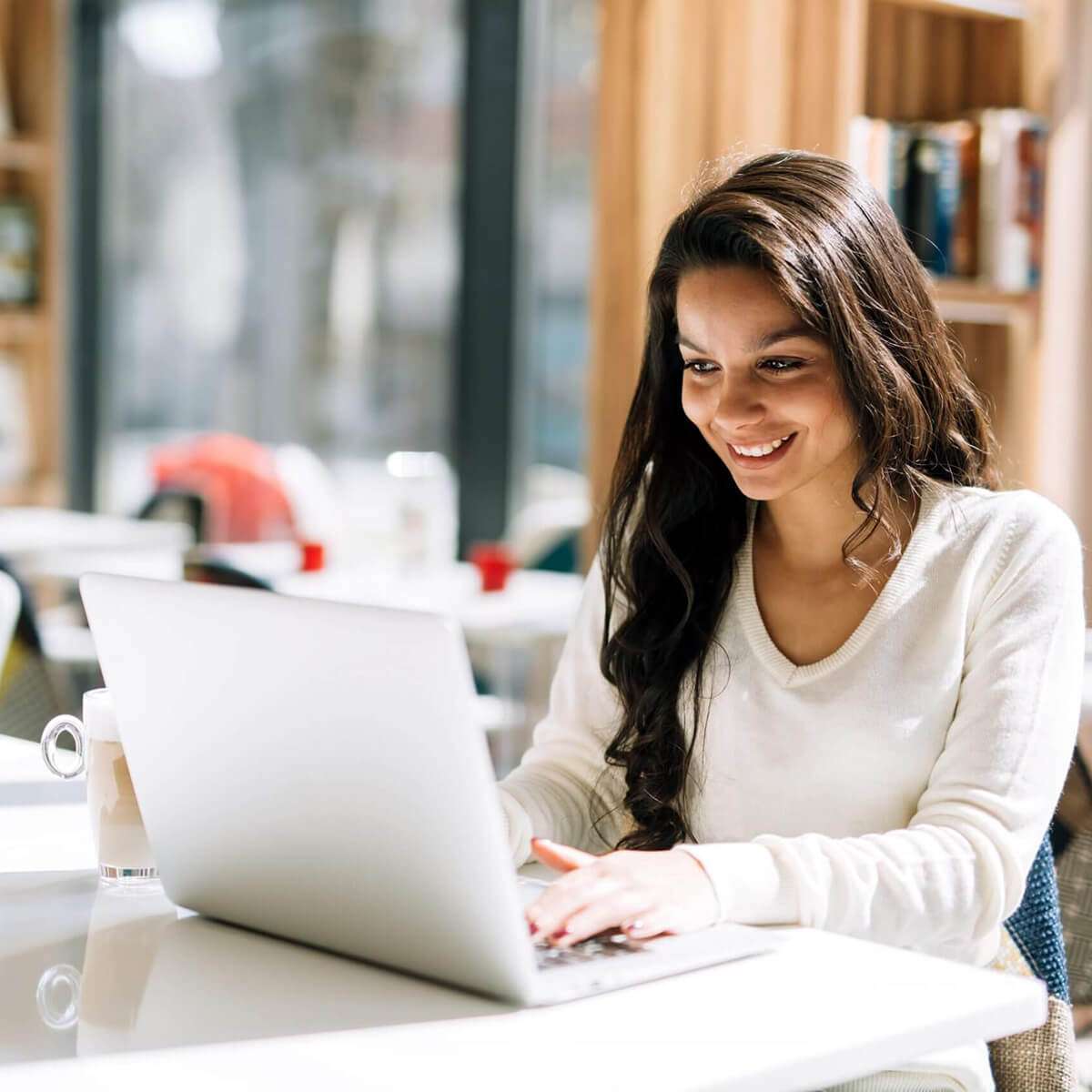 woman working on laptop in kitchen