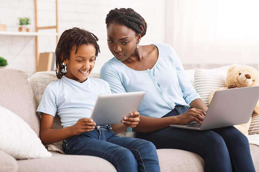 mother looking at her son's tablet