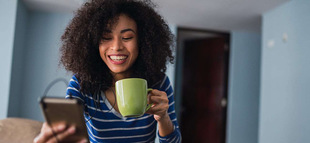 Smiling woman checks device compatibility - most phones are compatible