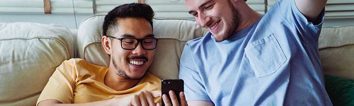 Two guys with mobile phone to transfer the phone number