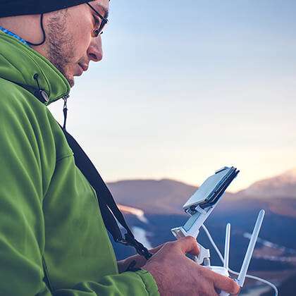 Man operates drone with mobile phone