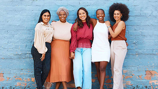 Five women standing together